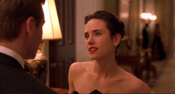 Movie still from “A Beautiful Mind” (2001), directed by Ron Howard – A woman in a strapless dress sitting in front of a lamp; Close Up shot, Over the shoulder angle