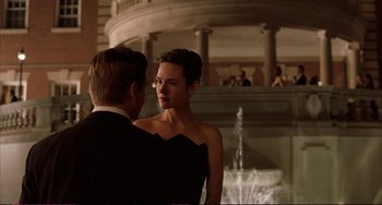 Movie still from “A Beautiful Mind” (2001), directed by Ron Howard – A man and a woman standing next to each other in front of a fountain; Medium shot, Low angle