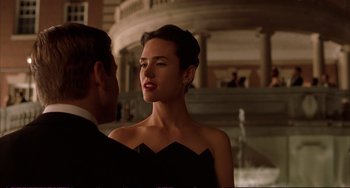 Movie still from “A Beautiful Mind” (2001), directed by Ron Howard – A man and a woman are standing next to each other in front of a fountain; Medium shot, Over the shoulder angle