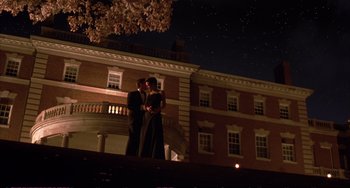 Movie still from “A Beautiful Mind” (2001), directed by Ron Howard – Two people standing next to each other in front of a building at night; Extreme Wide shot, Low angle
