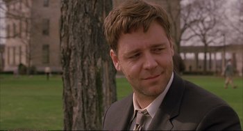 Movie still from “A Beautiful Mind” (2001), directed by Ron Howard – A person wearing a suit near a tree; Close Up shot, Over the shoulder angle