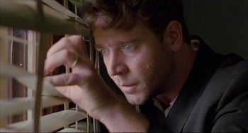 Movie still from “A Beautiful Mind” (2001), directed by Ron Howard – A person holding something in his hand; Close Up shot, Low angle