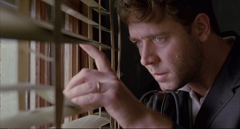 Movie still from “A Beautiful Mind” (2001), directed by Ron Howard – A person looking out a window; Close Up shot, Low angle