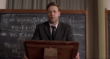 Movie still from “A Beautiful Mind” (2001), directed by Ron Howard – A man standing at a podium in front of chalkboards; Medium shot, Low angle