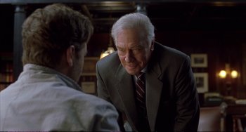 Movie still from “A Beautiful Mind” (2001), directed by Ron Howard – An older man wearing a suit talking to a younger man; Medium shot, Over the shoulder angle