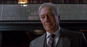 Movie still from “A Beautiful Mind” (2001), directed by Ron Howard – An older man wearing a suit and tie; Close Up shot, Low angle