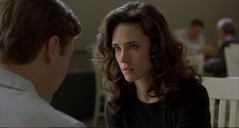 Movie still from “A Beautiful Mind” (2001), directed by Ron Howard – A woman with long hair and a black shirt is talking to a man; Close Up shot, Over the shoulder angle