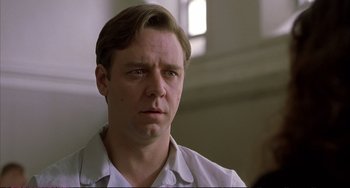 Movie still from “A Beautiful Mind” (2001), directed by Ron Howard – A person wearing a white shirt; Close Up shot, Low angle