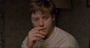 Movie still from “A Beautiful Mind” (2001), directed by Ron Howard – A man smoking a cigarette while wearing a white shirt; Close Up shot, Low angle