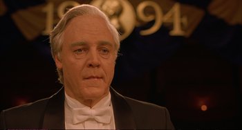 Movie still from “A Beautiful Mind” (2001), directed by Ron Howard – An older man wearing a tuxedo and a bow tie; Close Up shot, Low angle