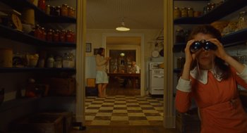 Movie still from “Moonrise Kingdom” (2012), directed by Wes Anderson – Two people are standing in a kitchen looking at each other; Wide shot, Over the shoulder angle