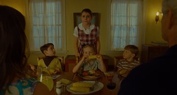 Movie still from “Moonrise Kingdom” (2012), directed by Wes Anderson – A group of children sitting at a table eating corn on the cob; Medium shot, Over the shoulder angle