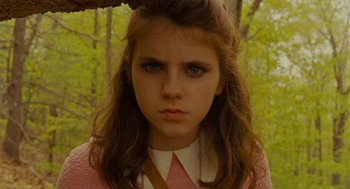 Movie still from “Moonrise Kingdom” (2012), directed by Wes Anderson – A young woman with a serious look on her face; Close Up shot, Low angle