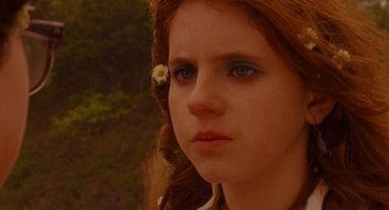 Movie still from “Moonrise Kingdom” (2012), directed by Wes Anderson – A person with a flower in her hair; Close Up shot, Over the shoulder angle