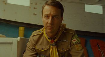Movie still from “Moonrise Kingdom” (2012), directed by Wes Anderson – A person wearing a uniform; Close Up shot, Low angle