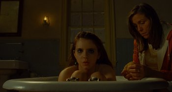 Movie still from “Moonrise Kingdom” (2012), directed by Wes Anderson – A woman sitting in a bath tub in a bathroom; Medium shot, Low angle