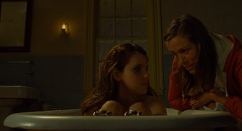 Movie still from “Moonrise Kingdom” (2012), directed by Wes Anderson – Two women sitting in a bath tub in a bathroom; Medium shot, Over the shoulder angle