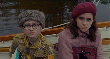 Movie still from “Moonrise Kingdom” (2012), directed by Wes Anderson – A boy and a girl sitting next to each other on a boat; Medium shot, Over the shoulder angle