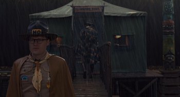 Movie still from “Moonrise Kingdom” (2012), directed by Wes Anderson – A man walking down a ramp in the rain; Medium shot, Over the shoulder angle