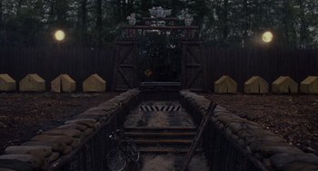 Movie still from “Moonrise Kingdom” (2012), directed by Wes Anderson – A bicycle parked on a bridge in a wooded area; Extreme Wide shot, High angle