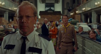 Movie still from “Moonrise Kingdom” (2012), directed by Wes Anderson – A group of people standing in front of each other; Medium shot, Over the shoulder angle