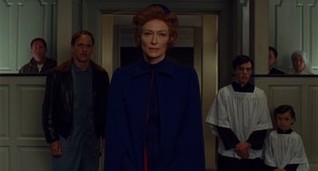 Movie still from “Moonrise Kingdom” (2012), directed by Wes Anderson – A group of people standing in front of a door; Medium shot, Low angle