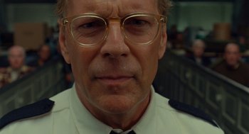 Movie still from “Moonrise Kingdom” (2012), directed by Wes Anderson – An older man wearing glasses and wearing a uniform; Close Up shot, Low angle