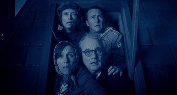 Movie still from “Moonrise Kingdom” (2012), directed by Wes Anderson – A group of men and women posing for a picture; Medium shot, Overhead angle