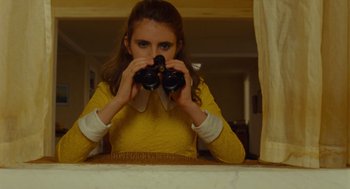 Movie still from “Moonrise Kingdom” (2012), directed by Wes Anderson – A woman looking through a pair of binoculars; Medium shot, High angle
