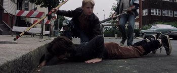 Movie still from “Mystic River” (2003), directed by Clint Eastwood – Two people are on the ground and one is holding a knife; Medium shot, High angle