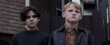 Movie still from “Mystic River” (2003), directed by Clint Eastwood – Two young men standing next to each other; Close Up shot, Low angle