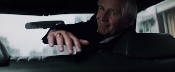 Movie still from “Mystic River” (2003), directed by Clint Eastwood – An older man sitting in the back seat of a car; Close Up shot, Low angle