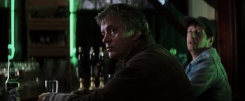Movie still from “Mystic River” (2003), directed by Clint Eastwood – A person sitting at a table; Close Up shot, Low angle