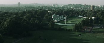 Movie still from “Mystic River” (2003), directed by Clint Eastwood – An aerial view of a football field and a stadium; Extreme Wide shot, High angle