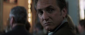 Movie still from “Mystic River” (2003), directed by Clint Eastwood – A man's face in front of lights; Close Up shot, Low angle