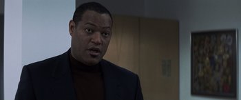 Movie still from “Mystic River” (2003), directed by Clint Eastwood – A man in a black jacket and a brown shirt; Close Up shot, Over the shoulder angle