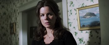 Movie still from “Mystic River” (2003), directed by Clint Eastwood – A person with long hair wearing a necklace; Close Up shot, Over the shoulder angle