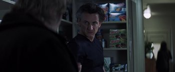 Movie still from “Mystic River” (2003), directed by Clint Eastwood – A man standing in front of a shelf of food; Close Up shot, Over the shoulder angle