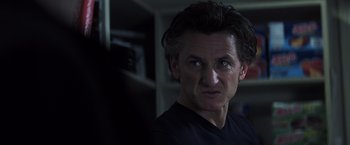 Movie still from “Mystic River” (2003), directed by Clint Eastwood – A person wearing a black t - shirt; Close Up shot, Over the shoulder angle
