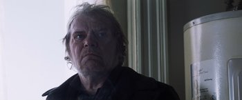 Movie still from “Mystic River” (2003), directed by Clint Eastwood – An older man with a frowning look on his face; Close Up shot, Low angle