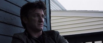 Movie still from “Mystic River” (2003), directed by Clint Eastwood – A person sitting on a chair near a window; Close Up shot, Low angle