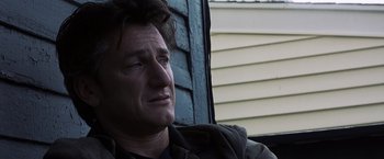 Movie still from “Mystic River” (2003), directed by Clint Eastwood – A person sitting on a chair; Close Up shot, Over the shoulder angle