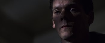 Movie still from “Mystic River” (2003), directed by Clint Eastwood – A person's face with a dark background; Close Up shot, Low angle