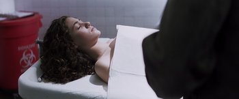 Movie still from “Mystic River” (2003), directed by Clint Eastwood – A woman laying on top of a white sheet; Close Up shot, High angle