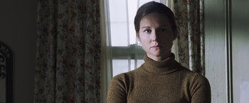 Movie still from “Mystic River” (2003), directed by Clint Eastwood – A woman in a brown sweater standing in front of a window; Close Up shot, Low angle