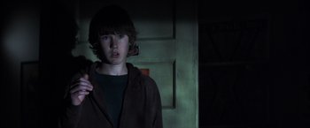 Movie still from “Mystic River” (2003), directed by Clint Eastwood – A young man standing in a dark room; Close Up shot, Over the shoulder angle