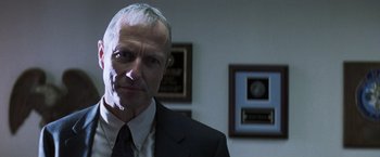 Movie still from “Mystic River” (2003), directed by Clint Eastwood – A person wearing a suit and tie; Close Up shot, Low angle