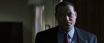 Movie still from “Mystic River” (2003), directed by Clint Eastwood – A man in a suit and a tie; Close Up shot, Low angle