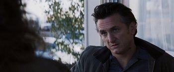 Movie still from “Mystic River” (2003), directed by Clint Eastwood – A person sitting in a chair near a window; Close Up shot, Over the shoulder angle