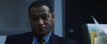 Movie still from “Mystic River” (2003), directed by Clint Eastwood – A man in a suit and tie; Close Up shot, Low angle